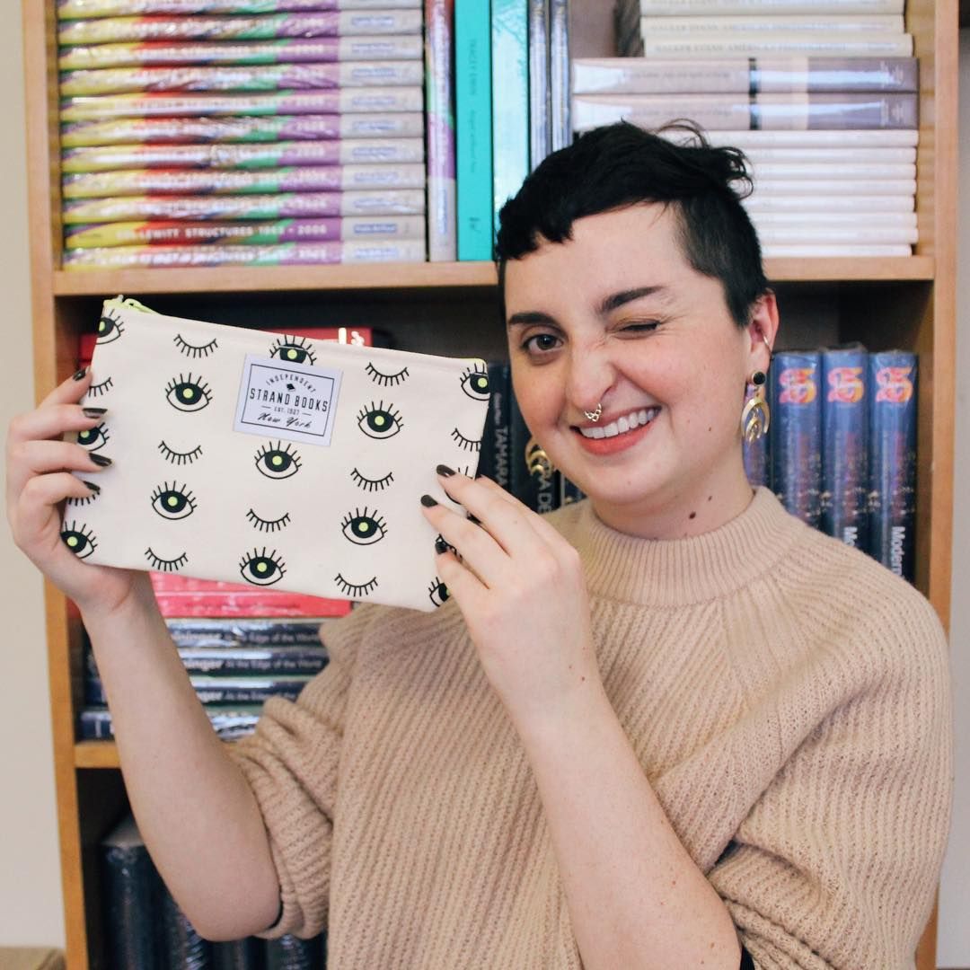 strandbookstore's tweet photo. Here's looking at you! 😉 Alison is modeling her latest design wit this new addition to our pouches. #strandstudio #pouch #wink https://t.co/z8VOKkQNRk https://t.co/3QEfjVszBu