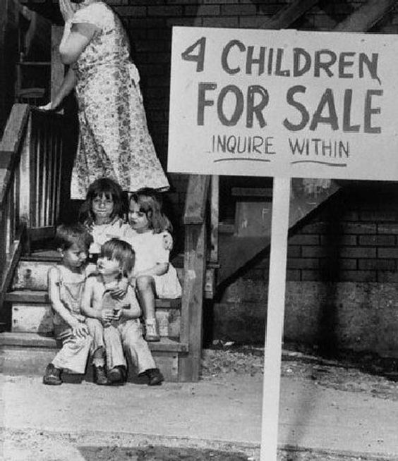 14. A penniless mother hides her face in shame after putting her children up for sale in Chicago, 1948.