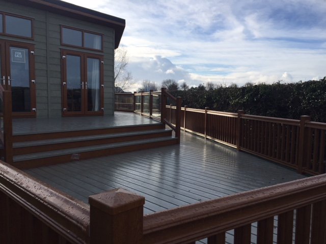 ABSundecksLtd's tweet photo. Stunning! Epic! Monumental! Even these words don’t fully describe the majesty of this huge deck at #Lakeways. Wrapping around the leisure home twice on two levels with golden oak balustrades and olive deck boards offering masses of entertainment space. https://t.co/oWdxY8jIS9