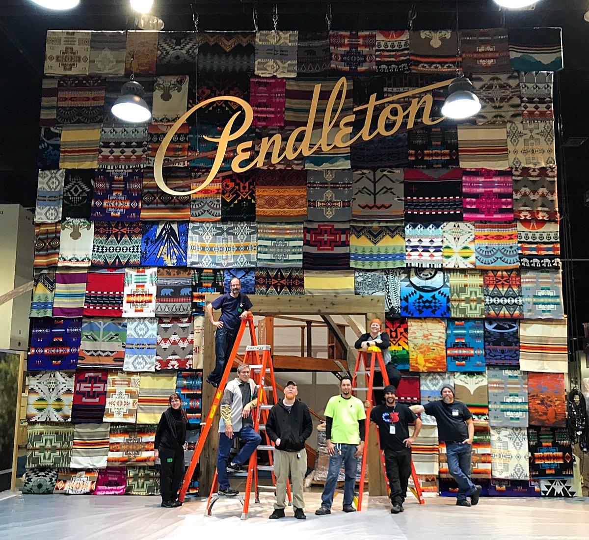 @Iatse local 7 stagehands with the amazing @PendletonWM wall of blankets built for #outdoorretail