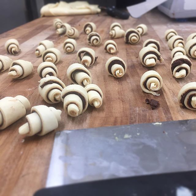 margotbakery's tweet photo. Rugelach on the baker's bench - we recently started making them with fully laminated dough so they are lighter. They're basically mini croissants with Valrhona chocolate filling now - same filling as the chocolate babka 😊 #rugelach #sourdough #minipa… https://t.co/jyriCMixzv https://t.co/gISAqtQ0Oq