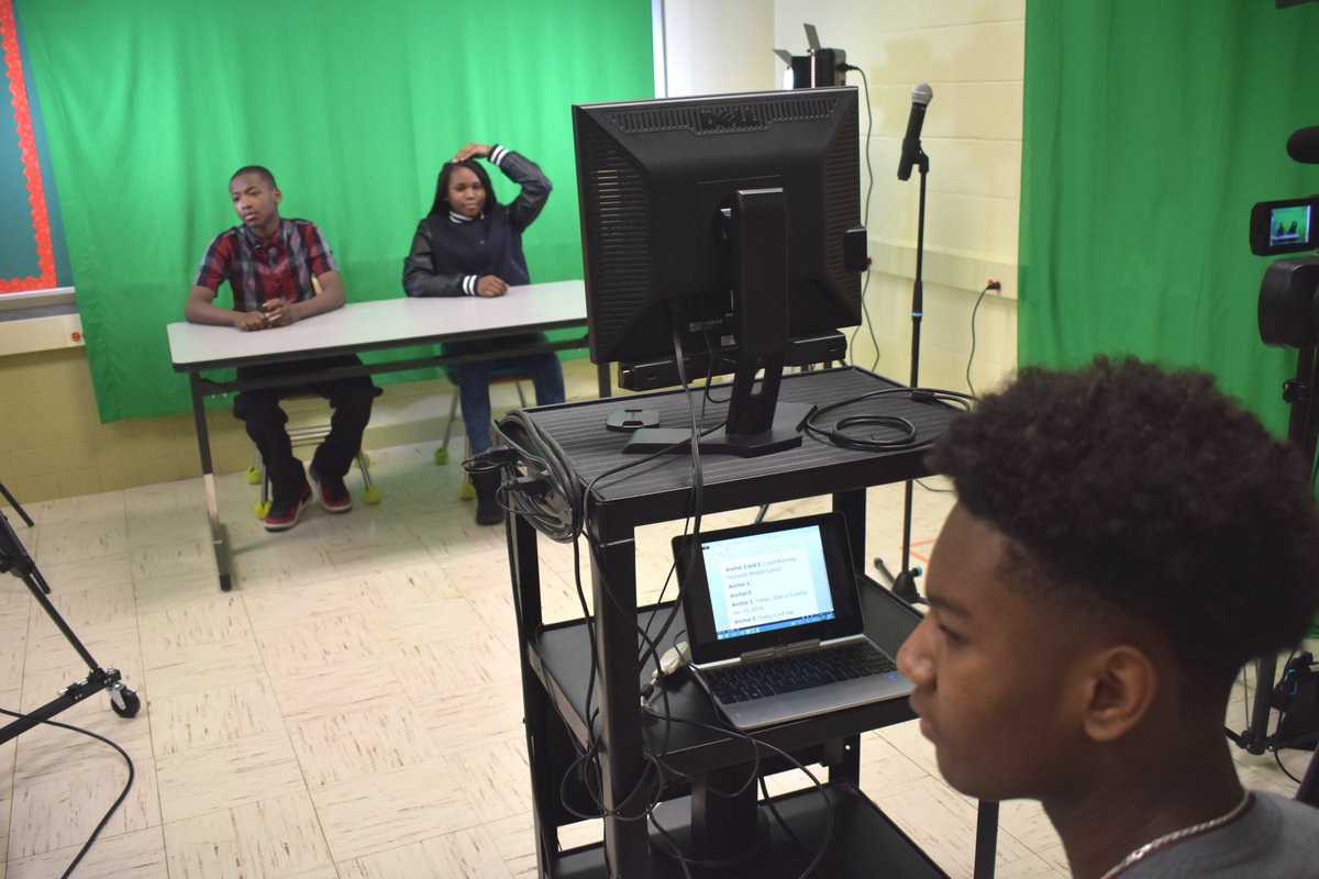 jmitraedu's tweet photo. In the Python Productions studio, communication is key. Here, the scriptwriter, anchors, and director discuss possible changes to our morning announcement script after doing a practice run. @kmiller2706 @PikesvilleM @AmyCFelton https://t.co/0zE5hKU1c8