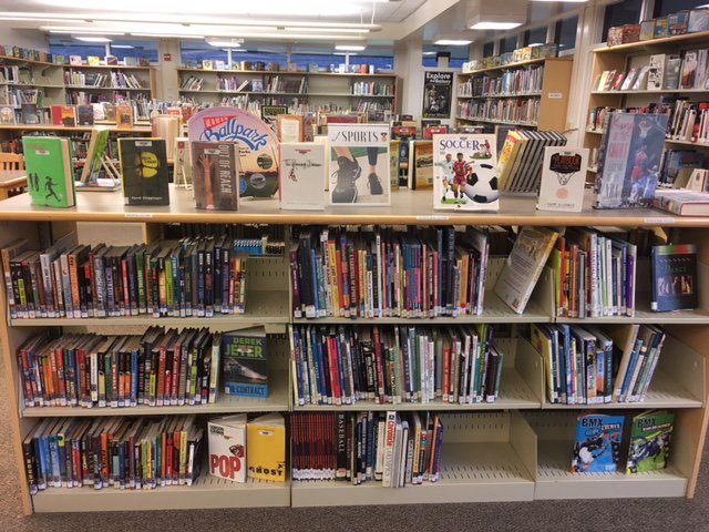 What's new in the CMS library? Genrefication! In order to help kids find books that match their interests, the fiction is being organized by genre (not alpha by author) and shelved side by side with related non-fiction. Sports book are pictured here.