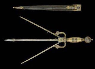 世界の武器防具百科 トリプルダガー 中世のヨーロッパ で使われていたパーリングダガーの一種 長さ 30cm 普段は普通の短剣の形状だが 手元のボタンを押すと二本の刃が左右にv字型に開く 敵の武器がレイピアなどの細い 剣の場合 この部分で