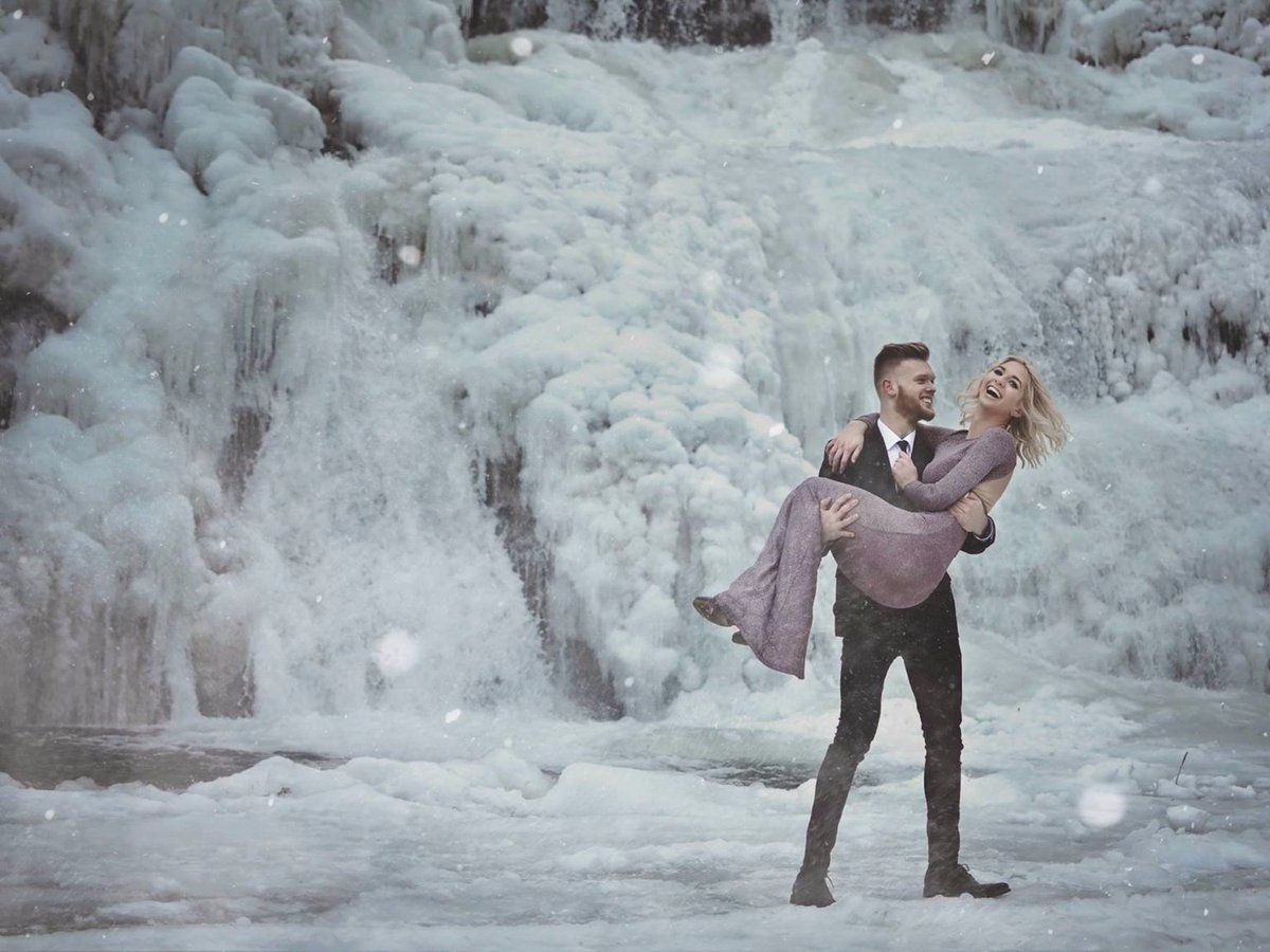 thisisinsider's tweet photo. A couple posed by a frozen waterfall for their engagement photos, and the pictures are so beautiful they'll give you chills ❄️ https://t.co/jlZHCbWrdm https://t.co/42T42V66Wt