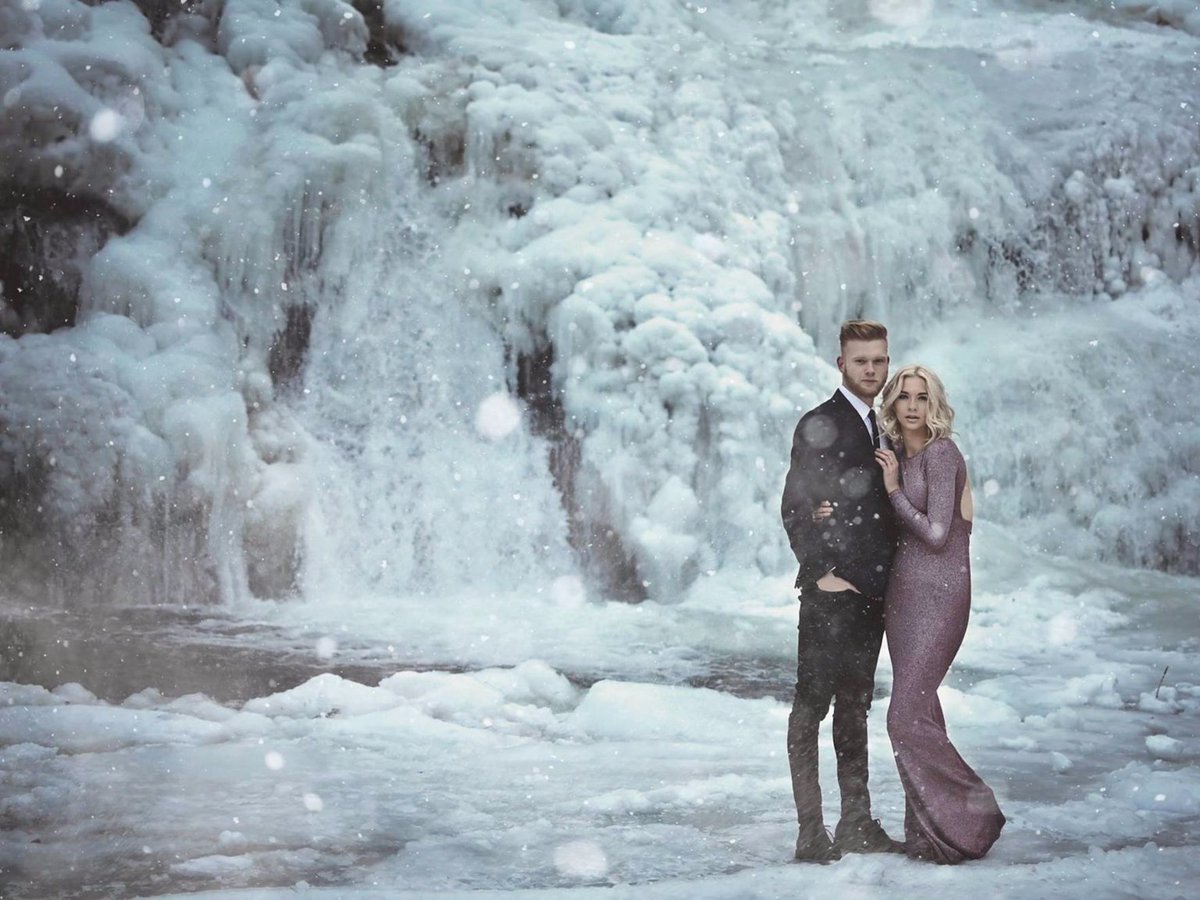 thisisinsider's tweet photo. A couple posed by a frozen waterfall for their engagement photos, and the pictures are so beautiful they'll give you chills ❄️ https://t.co/jlZHCbWrdm https://t.co/42T42V66Wt