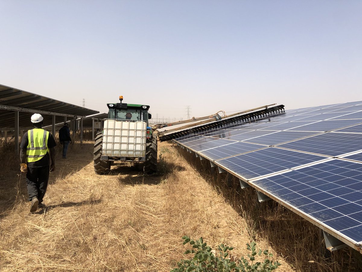 Cleaning solar panels at the Zagtouli power plant. www.theexchange.africa