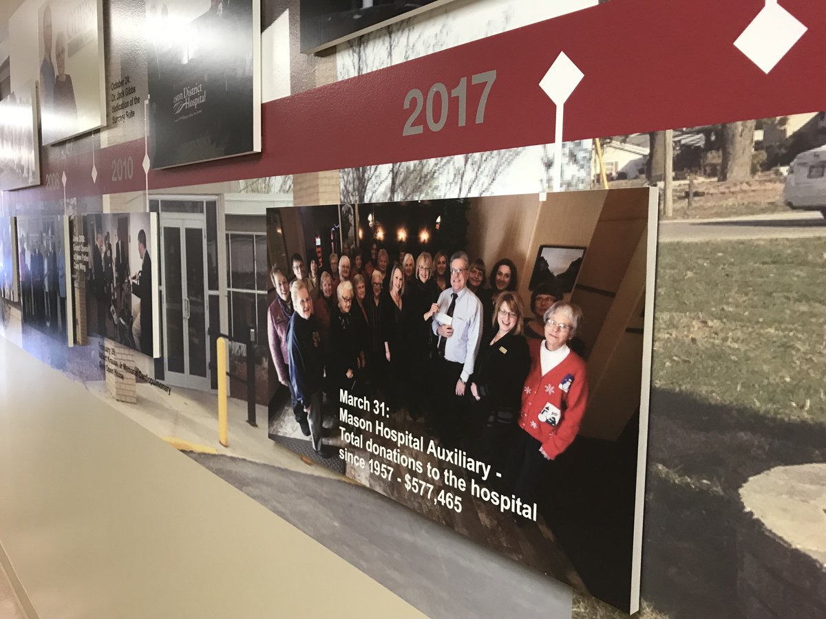 cmfigroup's tweet photo. After a few #signage projects at Mason District Hospital, we noticed many blank, white walls throughout their facility. We could see they had history and a story to tell. We came up with a solution, and here's the finished product. #heritagewall #60thanniversary https://t.co/AvXsjM8FDB