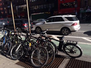 christineadair's tweet photo. Why do we allow cars to have so much of our public space? These bikes overflow onto the sidewalk where pedestrians walk. Take car parking away and allow bikes to park there! #streetvalues #healthystreets @NYC_DOT https://t.co/vYw77293Nr