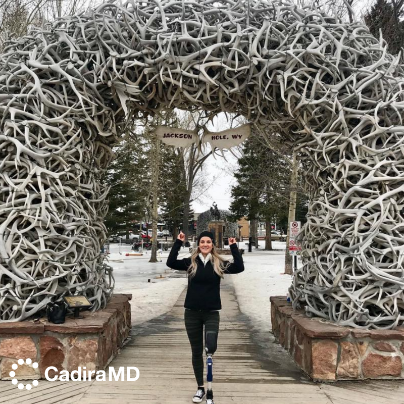 CadiraMD's tweet photo. Cadira Hero Kirstie Ennis at one of Jackson Hole's famous antler arches. #CadiraMD #WeAreCadira #CadiraHero #Fit #Military #Exercise #FitnessMotivation #StrongWoman #Workouts #StrengthOfAWoman #FitnessJourney #Wellness #LeftLegLess #WalkForACause #Veterans #MentalHealth https://t.co/JV5Db1BgtE