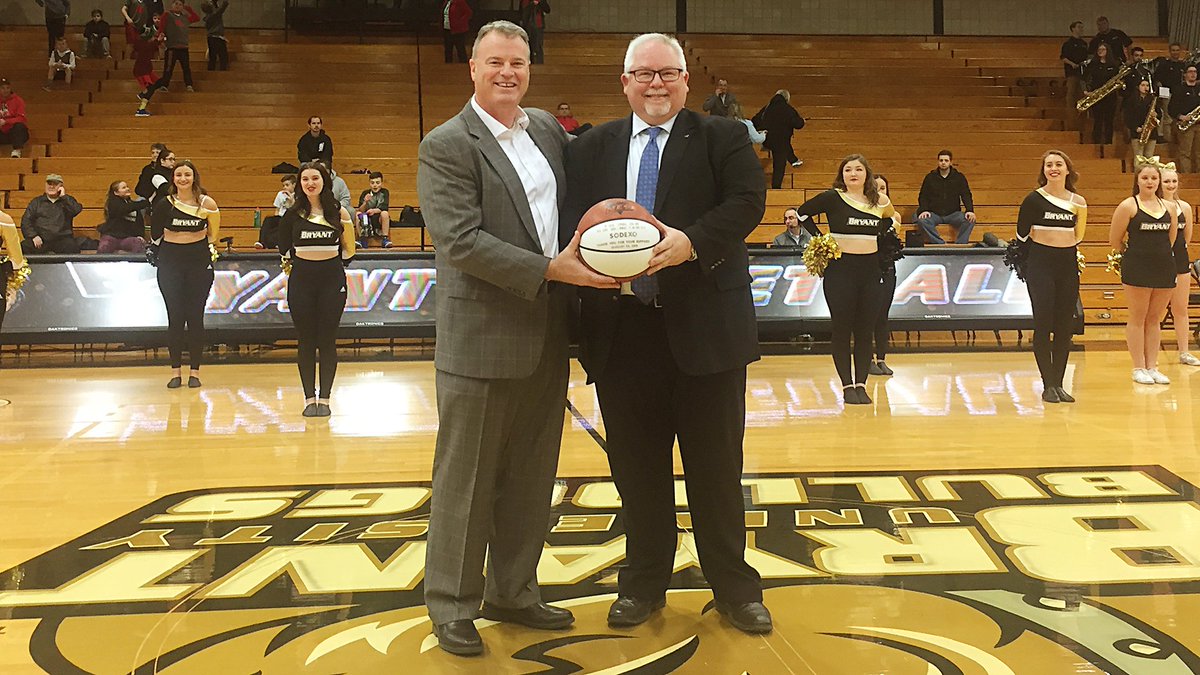 Director of Athletics Bill Smith presents Shawn Monaghan from Sodexo with a game ball prior to last night's game as we recognized our good friends at Sodexo as a proud corporate partner. Thanks for your support of Bryant Athletics!