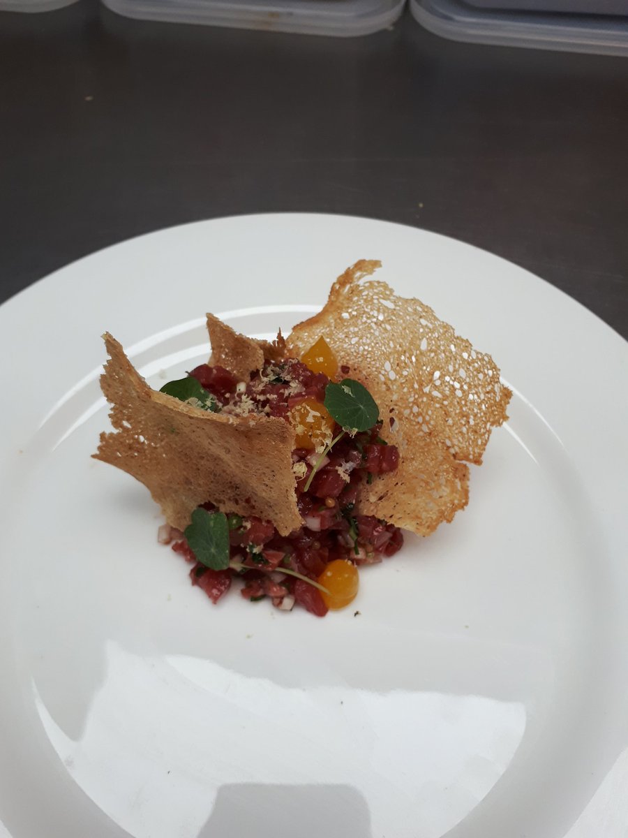 A twist on a classic, beef tar tar, egg yolk puree, baby sorrel, pickled mustard seeds and dripping croutons