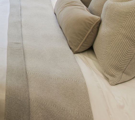 This luxurious master bedroom features textured neutral bed linen and throws, creating a tranquil atmosphere. #1508london #interiordesign #bedroomdesign
