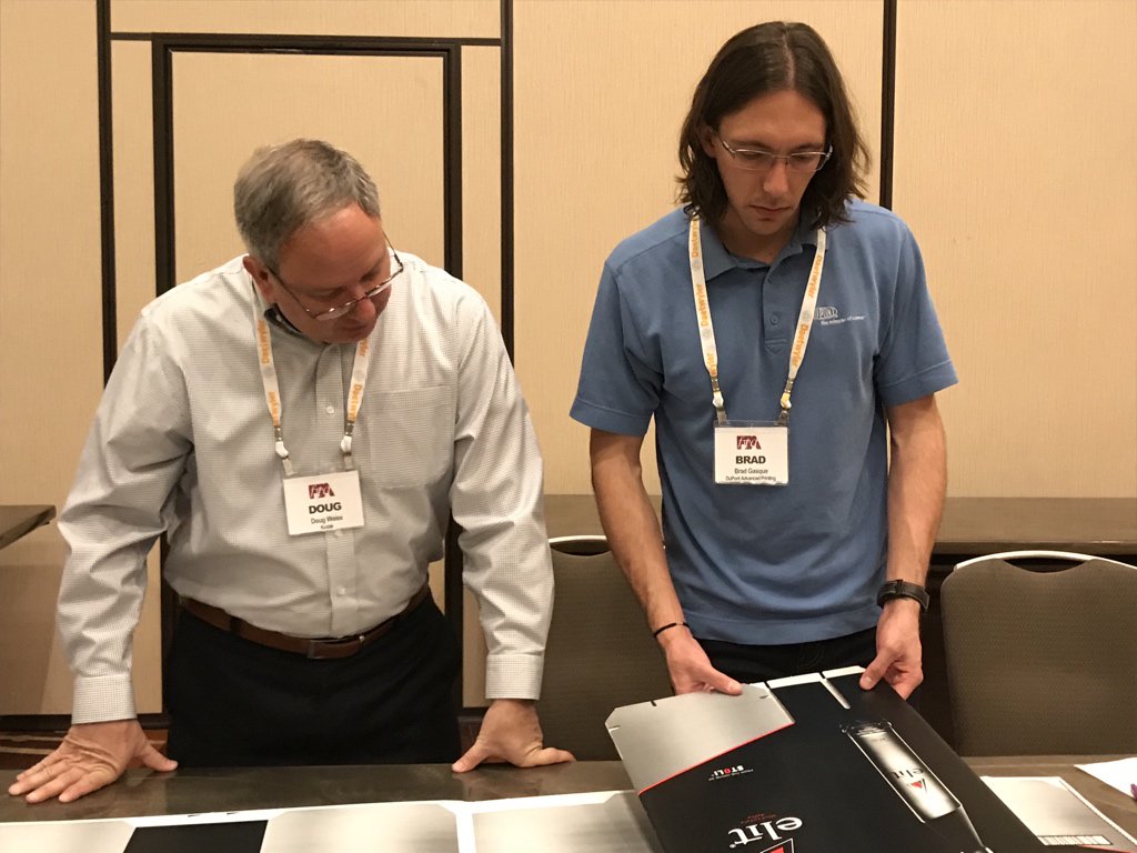 FlexTechAssn's tweet photo. Combined corrugated judges take a step back to examine an entry #Flexcellence https://t.co/RHcPvpGSUR
