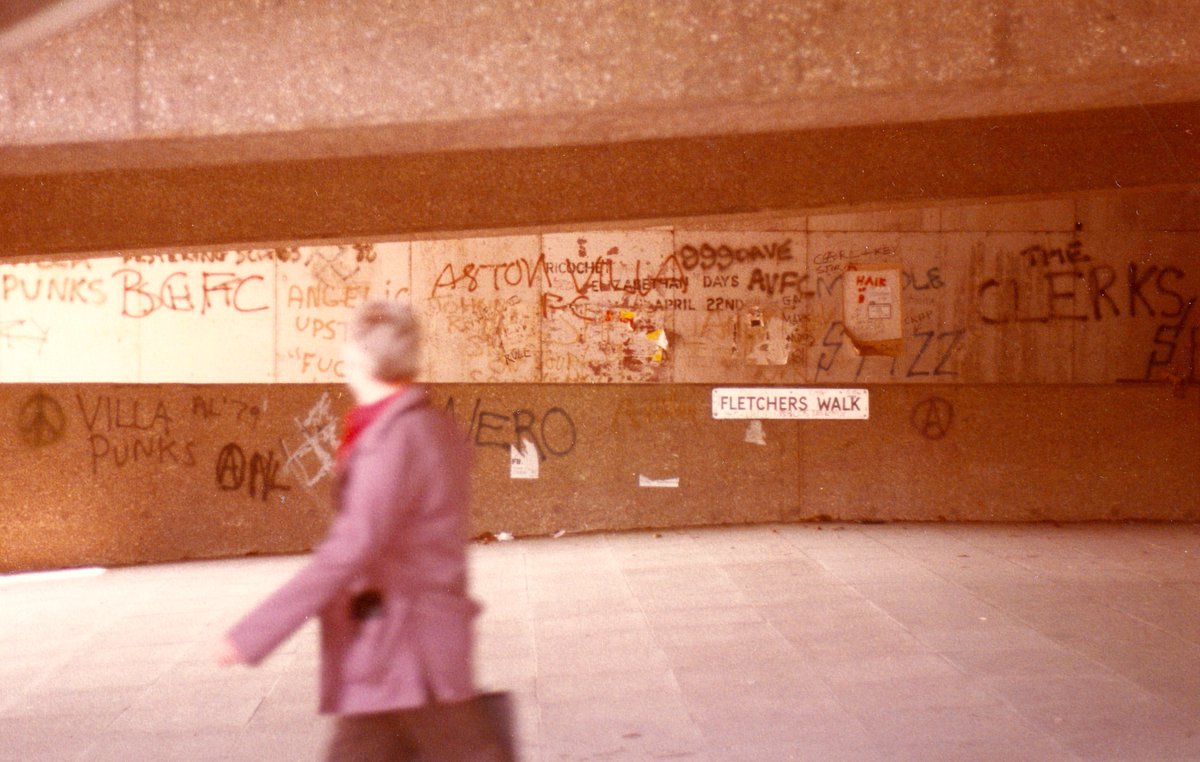 Fletchers Walk in Birmingham was demolished last month as the obliteration of John Madin's Paradise Circus scheme nears completion. Took this photo around 1982 with graffiti celebrating Villa Punks, @spizzenergi, 999, The Clerks (local punk/mod band), BCFC etc @Brumpic