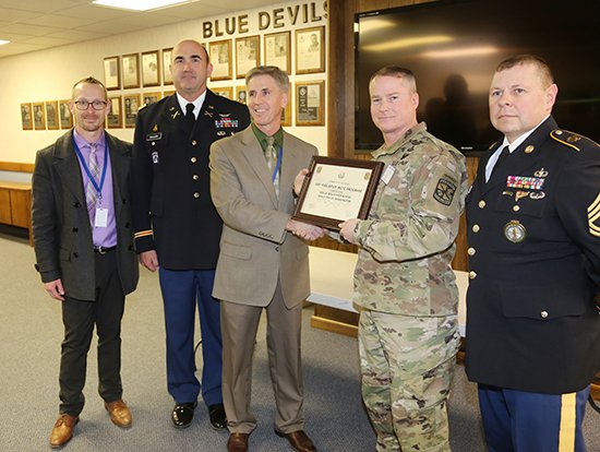Sgt. Maj. Mark Cashman presented the US Army Cadet Command Certificate to recognize the JROTC’s 100th anniversary as one of the nation’s first five original programs. Photo -  Sup't Wade Smith, Lt. Col. Bill Bialozor, Principal Ron Higgins, Cashman and Sgt. 1st Class Mark Mebes.