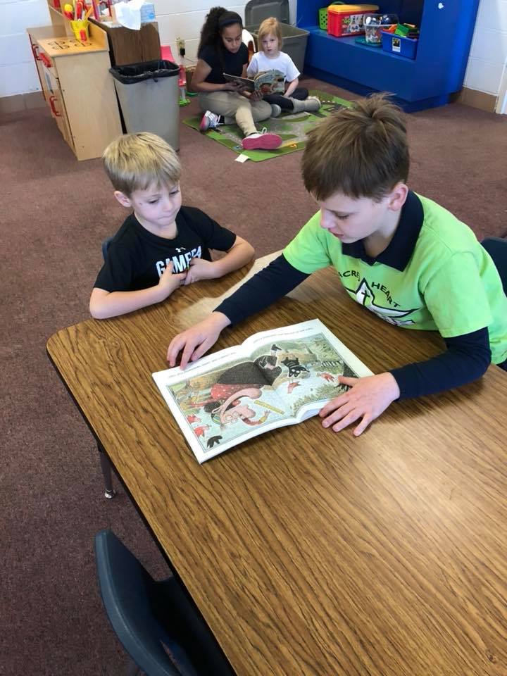 jpettykc's tweet image. The &quot;big kids&quot; came to spend time with the preschoolers during Catholic Schools Week. While there they helped us work on our literacy skills! #scpsi