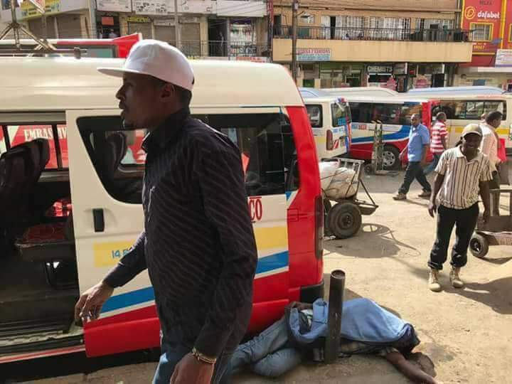 This man with a white cape is called Felix. He operates as a tout for Unique Shuttle at Tea Room. Felix allegedly beat up the man lying down on the ground and left him for dead. The man is fighting for his life at KNH. Felix is untouchable and operates with impunity.