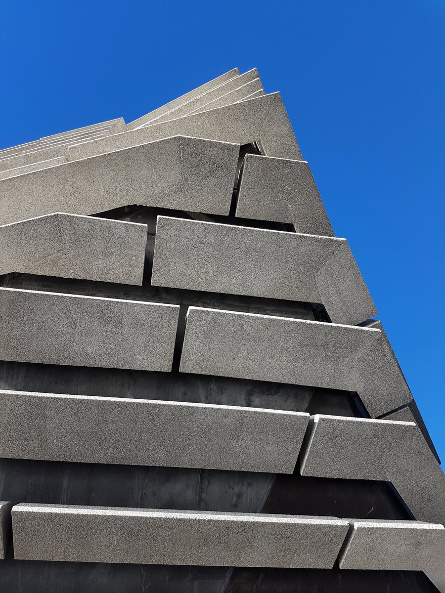 abstract shot of V&A Dundee building (large, dark grey covered in concrete cladding panels) taken from an extreme angle to exaggerate the corners and points.