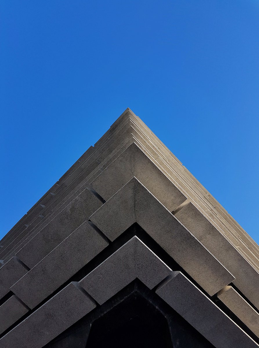 abstract shot of V&A Dundee building (large, dark grey covered in concrete cladding panels) taken from an extreme angle to exaggerate the corners and points.
