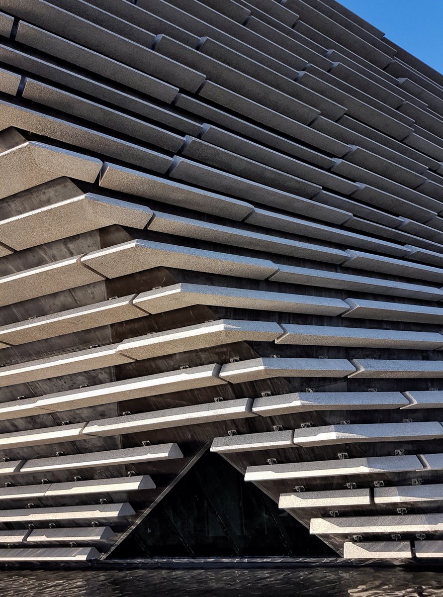 abstract shot of V&A Dundee building (large, dark grey covered in concrete cladding panels) taken from an extreme angle to exaggerate the corners and points.