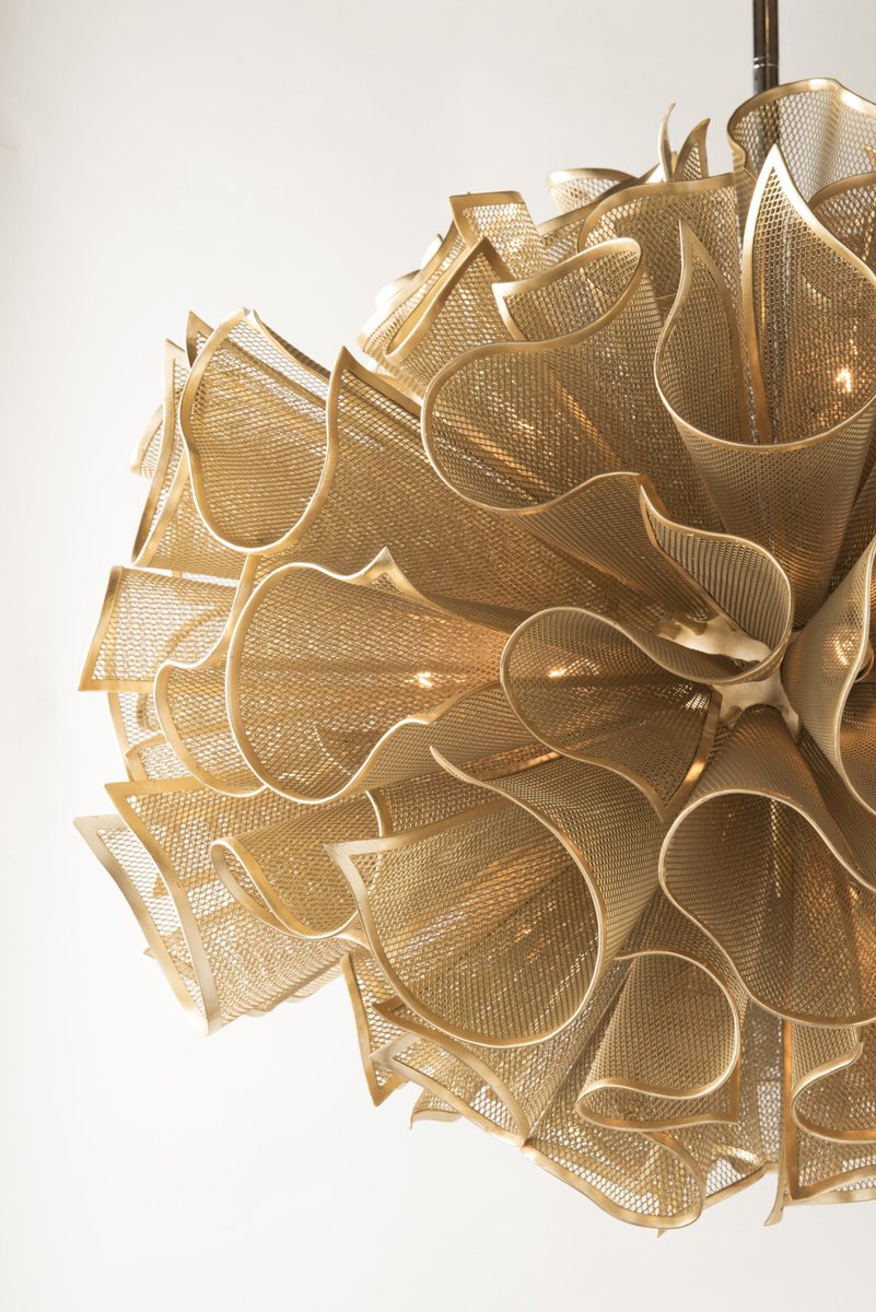 Corbett Lighting's Pulse pendant is created from handcrafted and folded iron mesh screens fit together, creating a suspended element in fluid motion. #corbettlighting