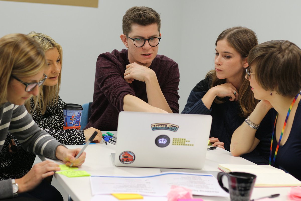 People gathered around a laptop