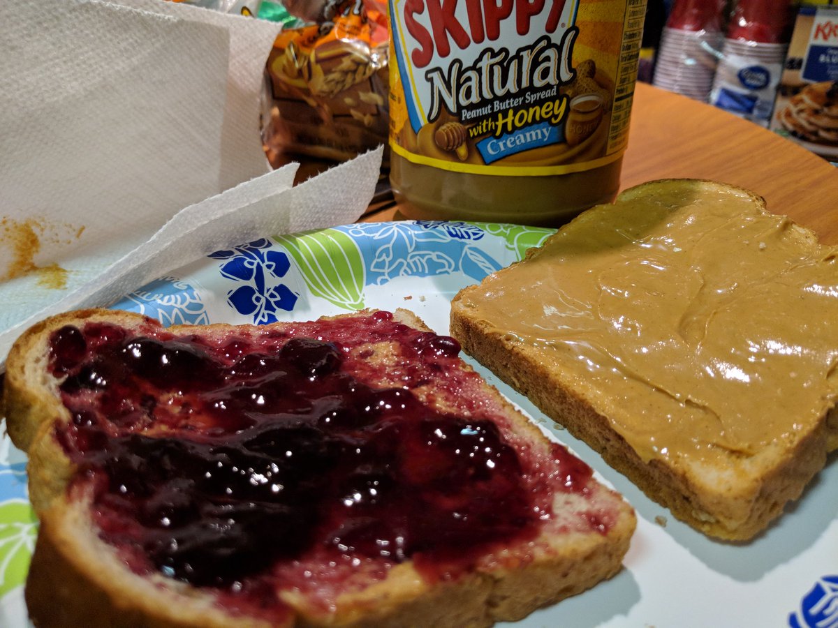 Tonight's dinner is a grape reduction with roasted peanut mash over two pieces of freshly baked bread.