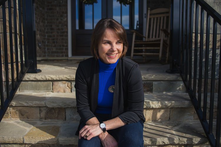 Angelika Kausche for Georgia House District 50; Angelika seated on steps in the sun.