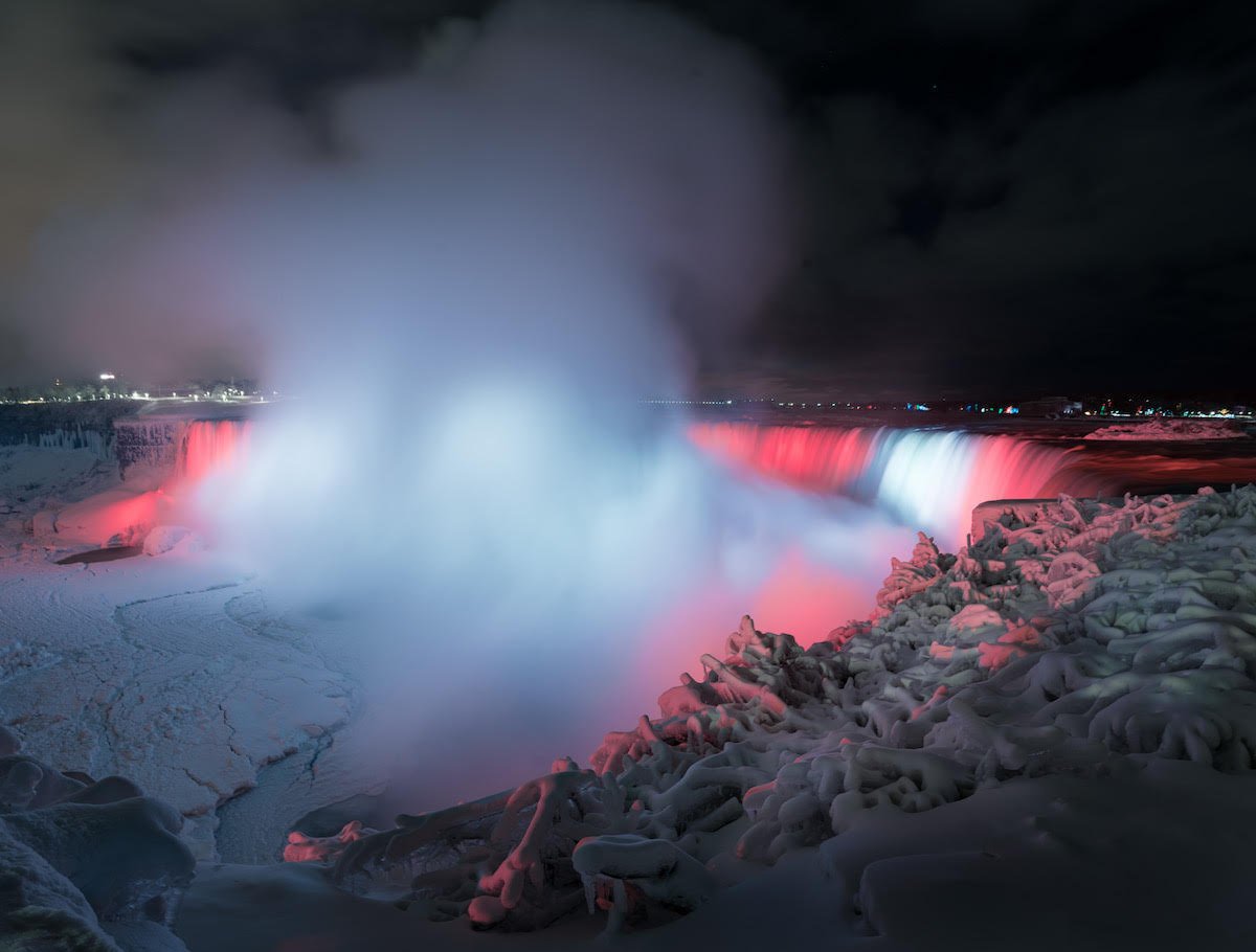 thisiscolossal's tweet photo. An Illuminated Niagara Falls Captured in a January Freeze by Adam Klekotka https://t.co/bHJEuvKO7W https://t.co/WbngR8MHo3