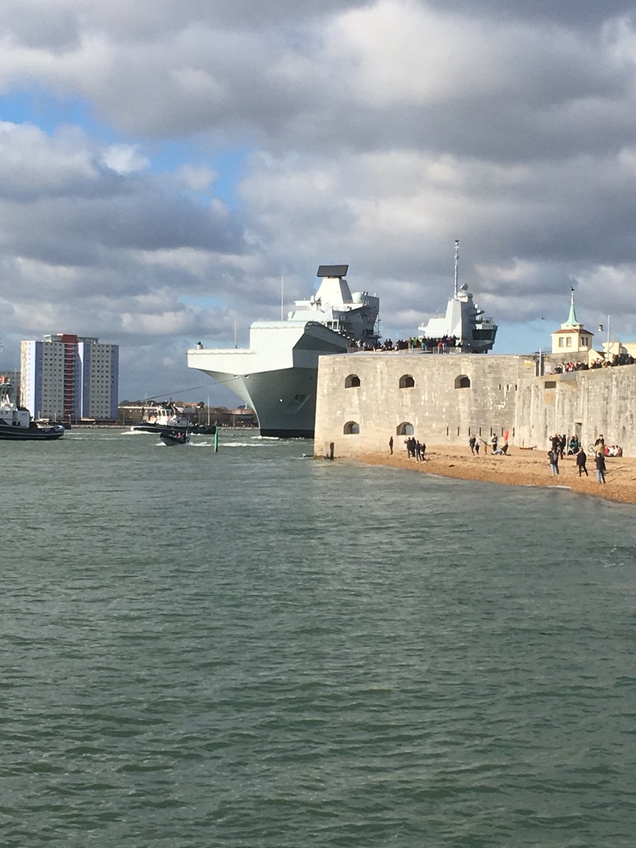 Queen Elizabeth now appears from behind round tower at Portsmouth harbour