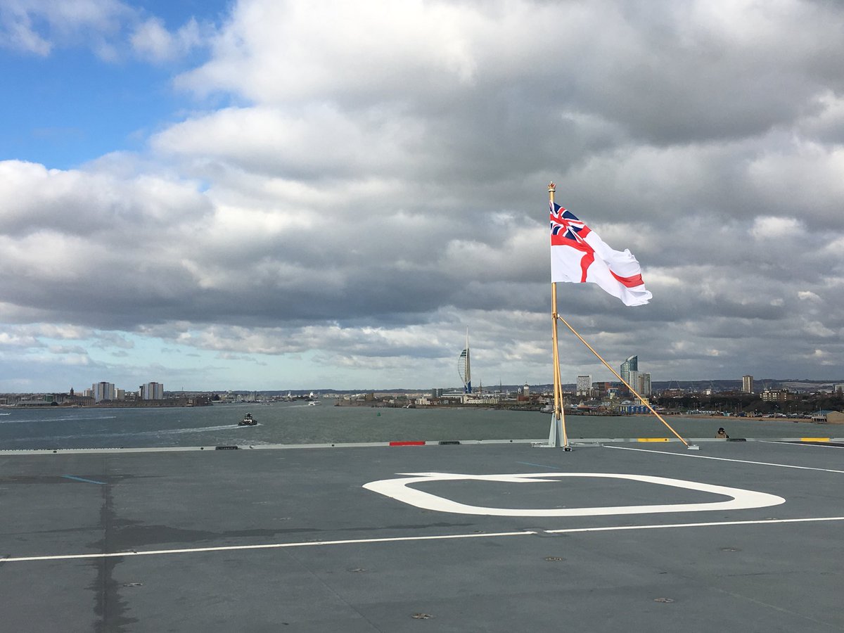 The Royal Navy Ensign is flying whilst Portsmouth slowly disappears in to the background.