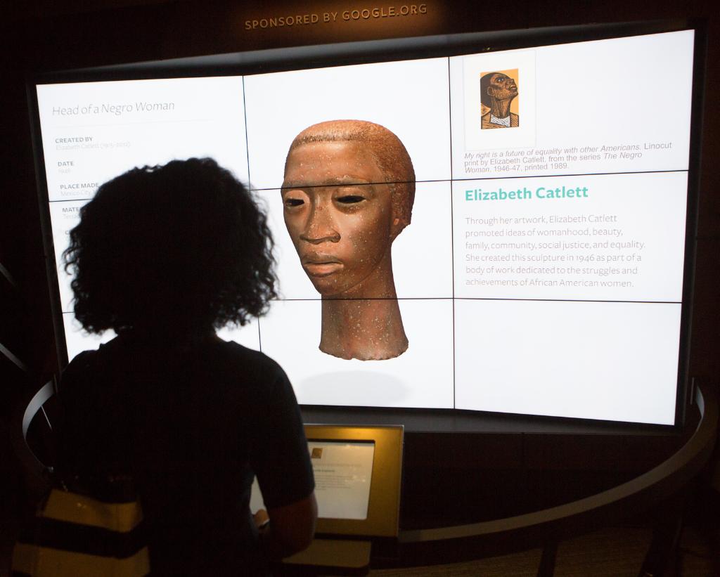Person stands in front of 3D installation at National Museum of African-American History and Culture.