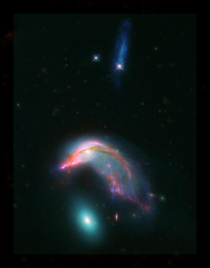 NASA's tweet image. Distant interacting galaxies – located 23 million light-years away – bear an uncanny resemblance to a penguin guarding an egg. Learn about this pair that has a mutual gravitational attraction, slowing dragging them closer together: go.nasa.gov/2EcCH2g