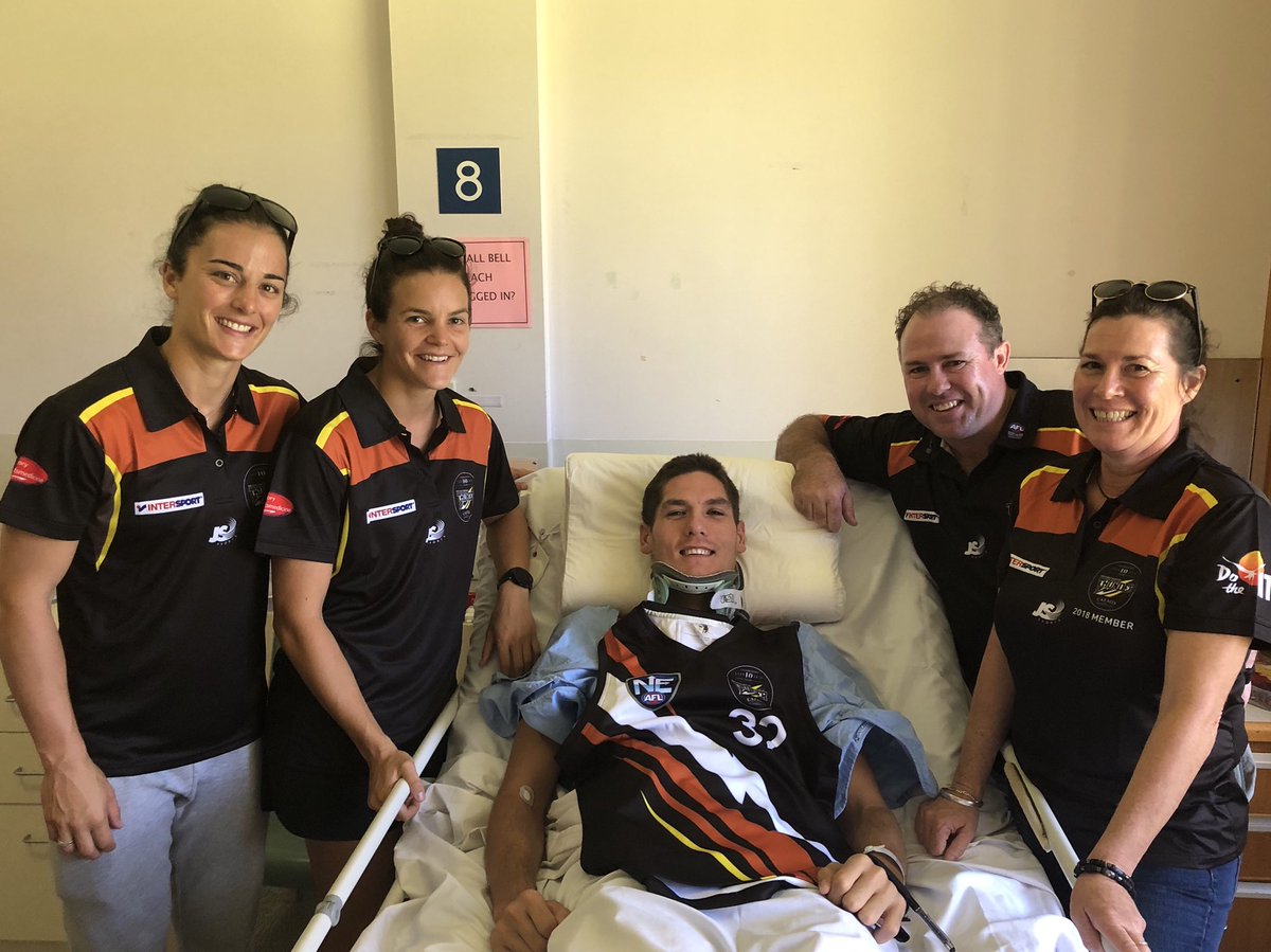 NTThunderFC's tweet photo. Head Coach @AndrewHodges43, with Belinda Creer, @AngelaFoley_3 &amp; @sallyriley_8 presented Tai with his 2018 jumper and player’s kit. He may have a good excuse to get out of training &amp; not put up with Hodgo’s dad jokes but he’s very much part of our #thunderfamily #HelpTaiWalkAgain https://t.co/Qt3gZMEaRV