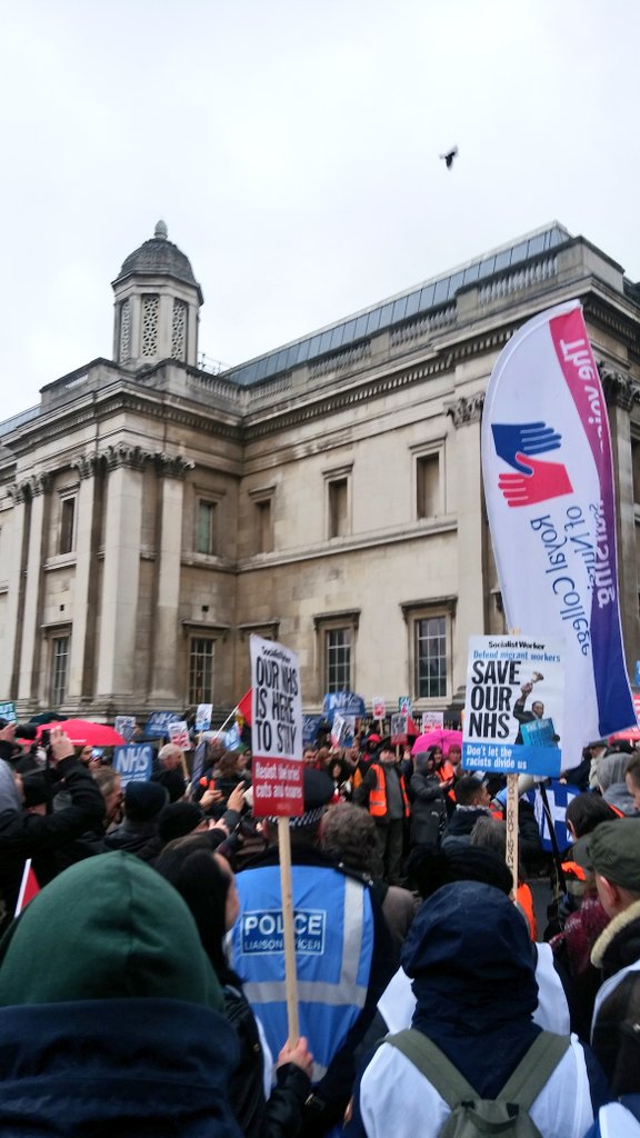 RCNLibraries's tweet photo. The #FundOurNHS march has made it to Trafalgar Square. Great support on such a dismal day! Keep it up everyone. 💪 @theRCN will fight for nurses! #ClosetheGap https://t.co/x1m0s5DJYc