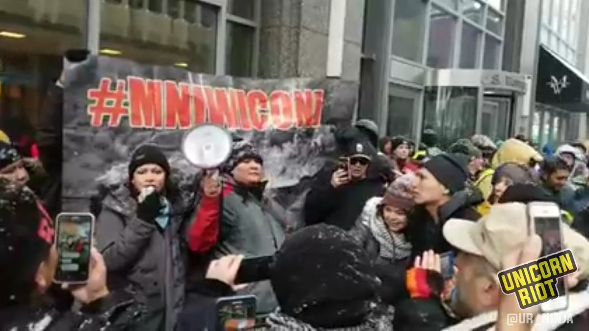 UR_Ninja's tweet photo. Water protectors from across the #midwest demand US Bank #divest from #fossilfuel extraction projects: https://t.co/8VgbQoyGRd #SB52 #NoDAPL #SuperBowl https://t.co/WX0IXuAkxr