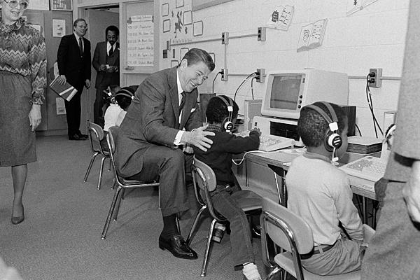 Ronald Reagan helps some kid use a IBM PC.