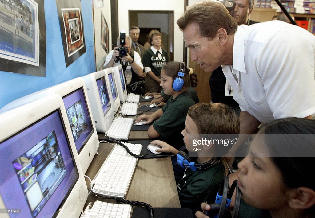 In 2003, Arnold Schwarzenegger looks over the shoulders of some schoolkids, during his run for California Governor.