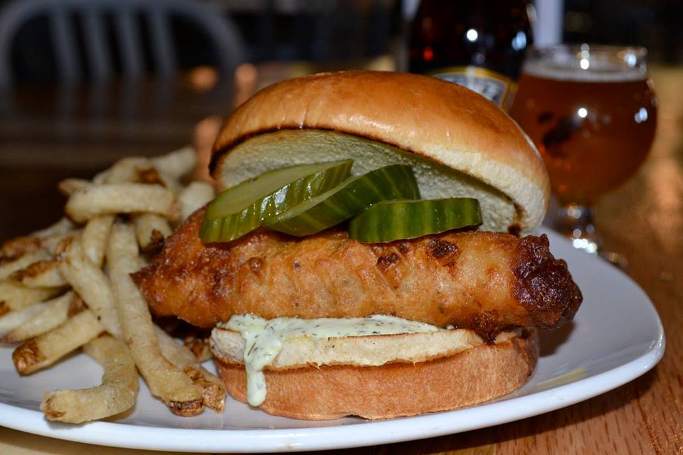 AkademiaBC's tweet photo. Now available on #AkademiaBC's weekday lunch menu: our battered fish sandwich! Chef's choice ale, cod, lemon-jalapeño tartar sauce, house pickles and fries for $9! Order Monday through Friday, 11 a.m. to 3 p.m. We paired this one with #IQIPA. https://t.co/0IkSgt9J0w