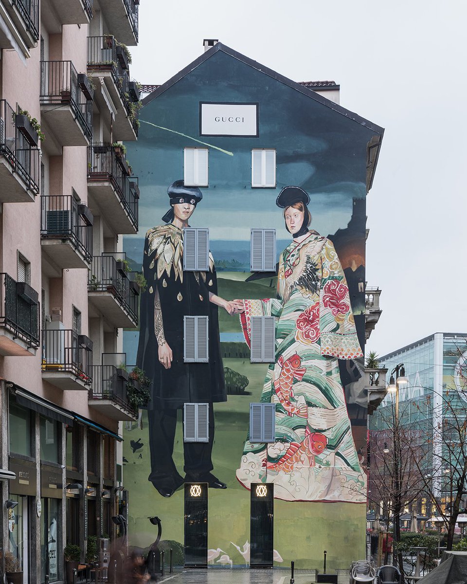 gucci's tweet photo. The #GucciArtWall in Milan’s Largo la Foppa, a work from the #GucciSS18 campaign #GucciHallucination by #IgnasiMonreal, inspired by ‘The Garden of Earthly Delights’ (1490-1500) by Hieronymus Bosch and the couple in ‘The Arnolfini Portrait’ by Jan van Eyck (1434). https://t.co/mtEGBRbaZv