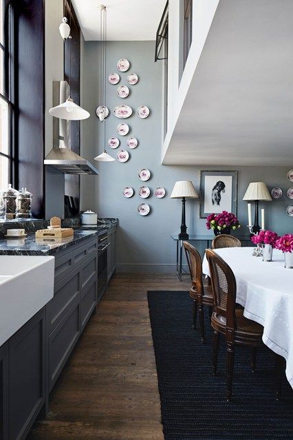 _houseandgarden's tweet photo. The double height of this kitchen and dining room in a former schoolhouse is emphasised by pendant lights on long cords and decorative plates rising up to the ceiling. https://t.co/d3zjnu5AiJ https://t.co/WN7Sm1yu8d