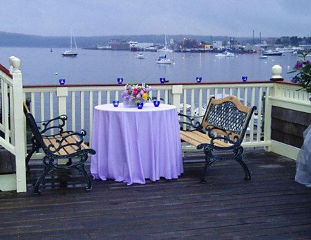 While this space now has an awning to protect from heat and rain, the view is still the same. #harborhouse #gloucesterma #gloucesterevents