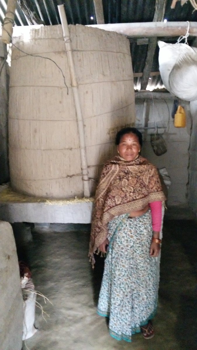 ColinMcQuistan's tweet photo. Mrs Mana Kumari Tharu proudly showing her improved grain store provided by @PracticalAction @Zurich supported flood resilience project in Nepal, by raising the store a few feet of the ground she feels confident her rice will not perish while she is forced to the flood shelter https://t.co/yP3oZKkadP