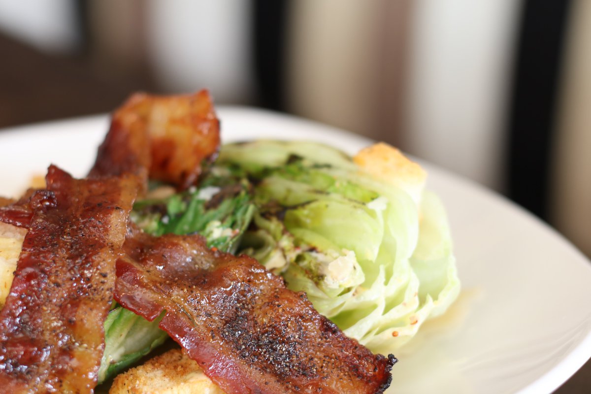 Table21Vic's tweet photo. Start your meal with our delicious Grilled Romaine Salad. Romaine hearts, candied bacon, shaved Grana Padano, croutons, house made Caesar dressing. #table21vic #yyj https://t.co/eHJULrm0oI