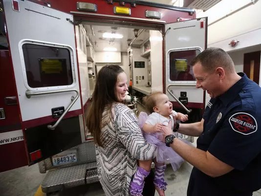 KitsapSun's tweet photo. Eleanor Rogers was born on Feb. 6, 2017, in the back of a North Kitsap Fire and Rescue ambulance during a snowstorm. On Tuesday, Eleanor's parents brought her to the fire station to say thanks to the firefighters who helped: https://t.co/6Jc40tv5fy https://t.co/xX8hS2KpuM