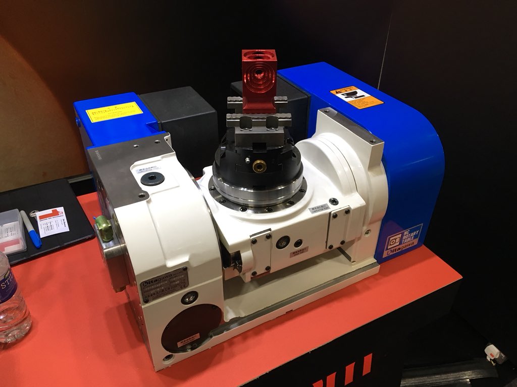 Alex1MTA's tweet photo. Seen a lot about #5axis today at #southmanf. If you haven’t got space or want to make use of a current VMC @Kitagawachucks may be able to help. On our stand we have a TT150 which allows for full 5 axis machining on a standard 3 axis #CNC #Milling machine. https://t.co/WVOTpCQdRB