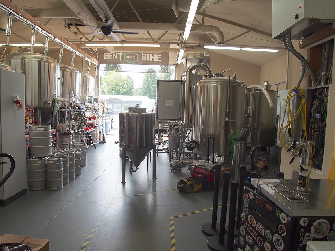 A nice, bright, modern taproom. Comfortable and friendly. There’s a concrete topped bar &amp; three long tables with many bar stools, as well as an outdoor area with picnic tables. 11 beers on tap. We liked the Saison &amp; the CDA, both good. @ Bent Bine Beer Co.