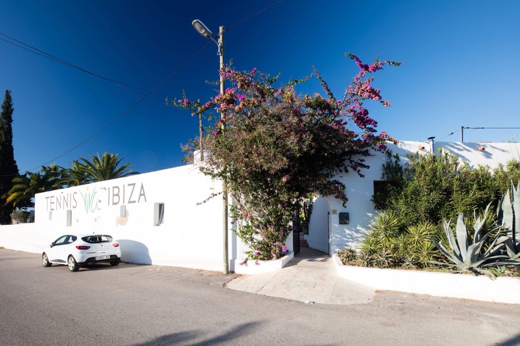 VivaTennisIbiza's tweet photo. The entrance to @VivaTennisIbiza is unlike any other venue in the world. Think: sunny skies, warm air as you make your way through the charming, authentic Spanish finca gate, over which an impressive purple Bougainvillea climbs to frame the entrance with elegance. #tennis #Ibiza https://t.co/rV50c6rfeQ