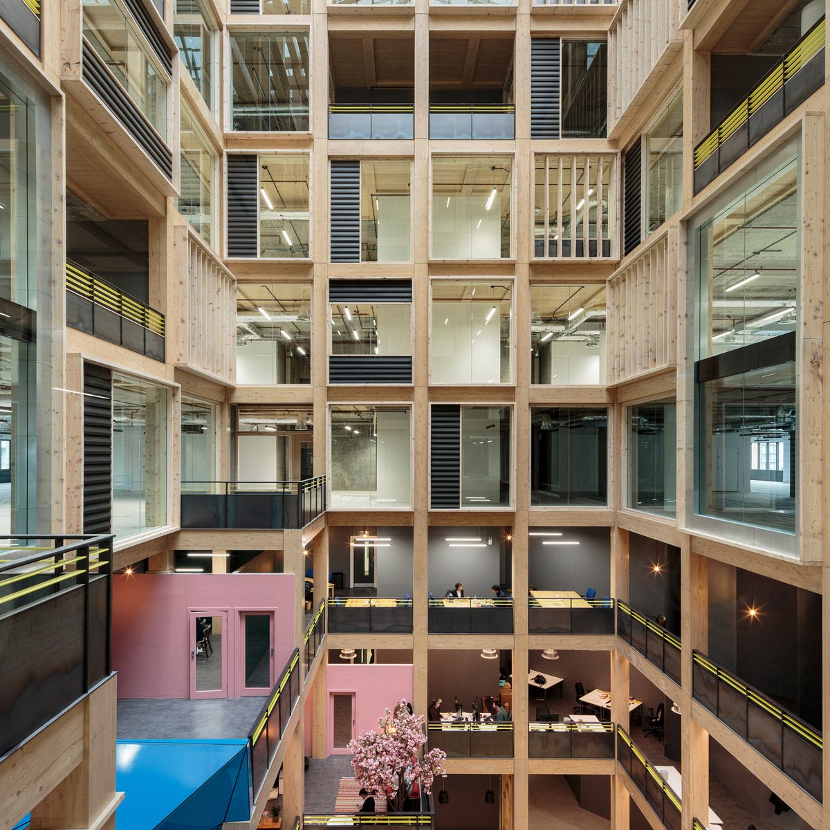 dezeen's tweet photo. Drone footage reveals 10-storey timber atrium by Studio RHE https://t.co/lN0m7YjreY https://t.co/AuXmlUIbGB